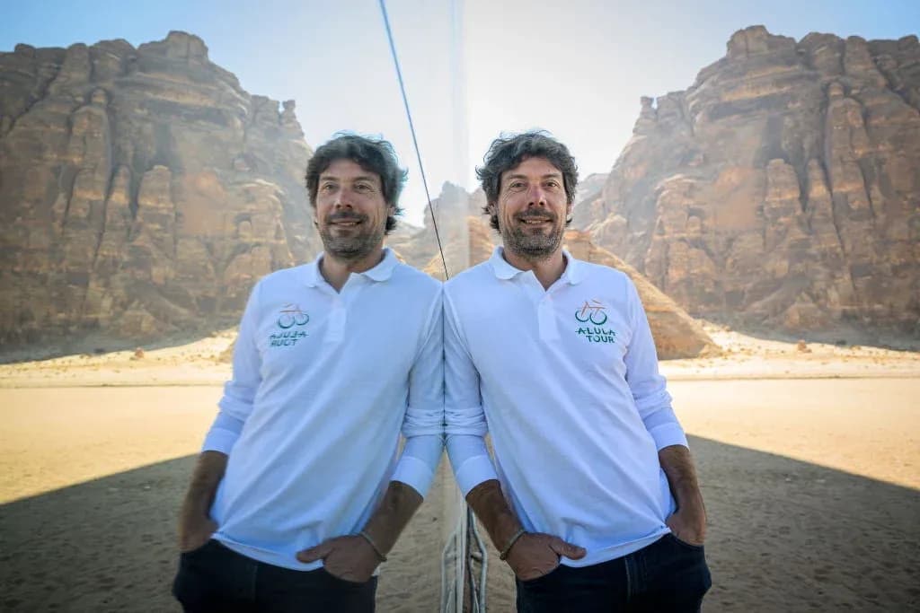 Man in white polo shirt standing in desert