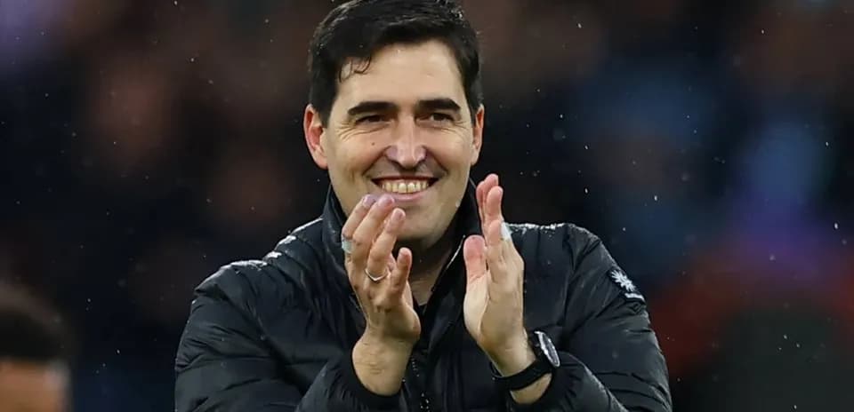 Coach applauding in the stadium during match