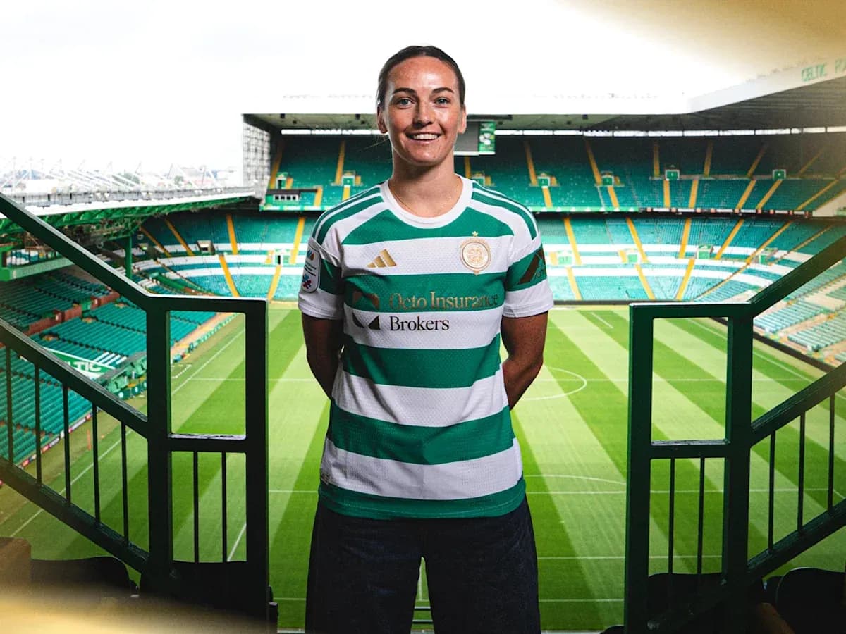 Player posing in Celtic jersey at stadium