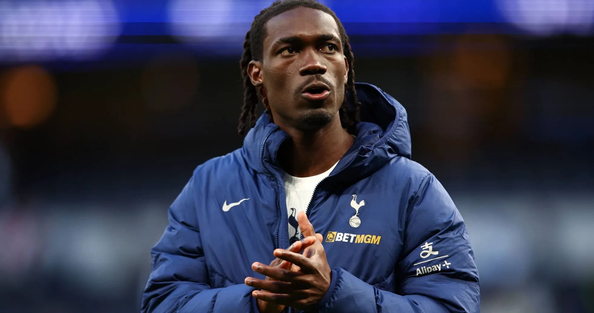 Player in Tottenham jacket clapping hands on field