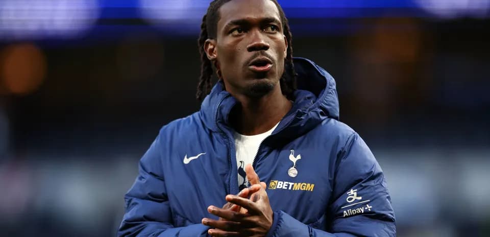 Player in Tottenham jacket clapping hands on field