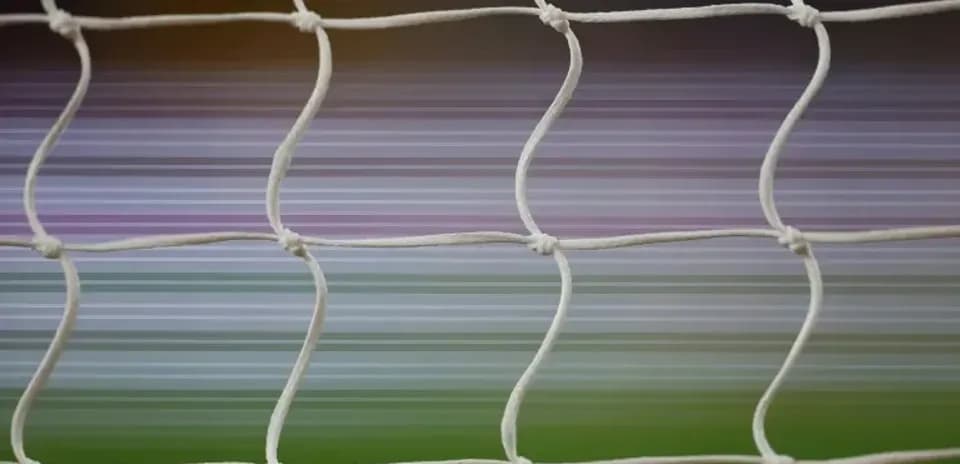 Close-up of soccer goal net with blurred background