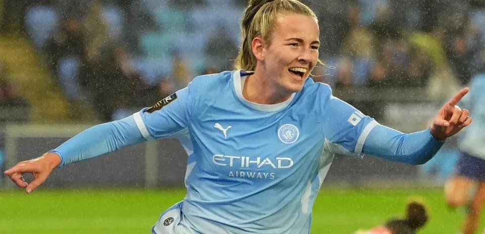Player celebrating goal in Manchester City kit