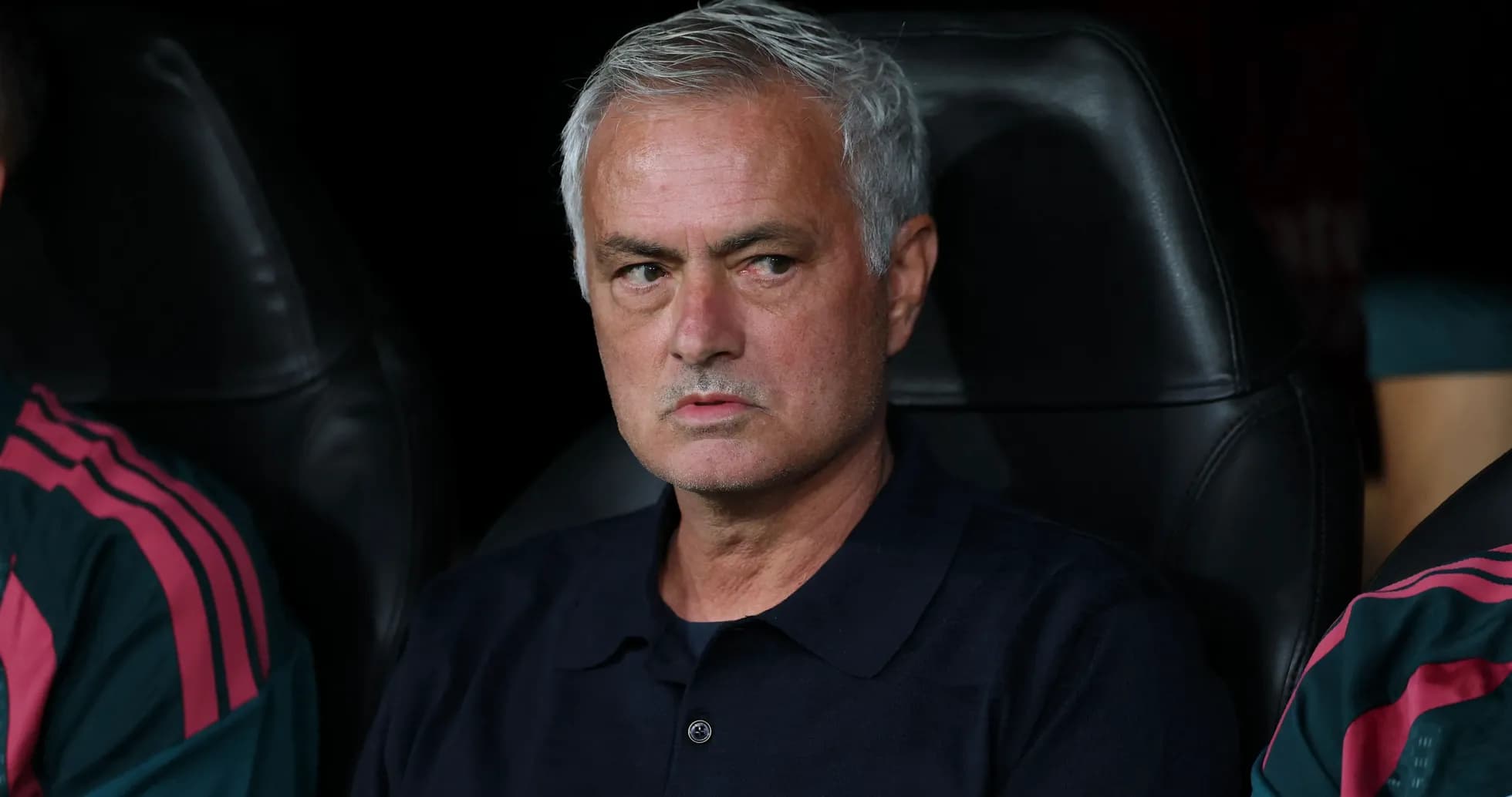 Manager seated on bench during match