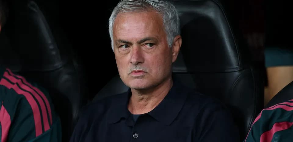 Manager seated on bench during match