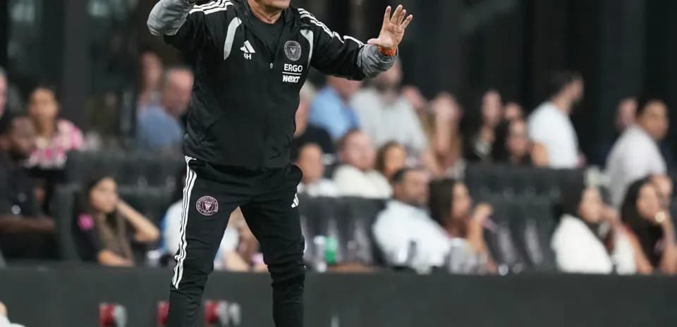 Coach gesturing from the sidelines during match