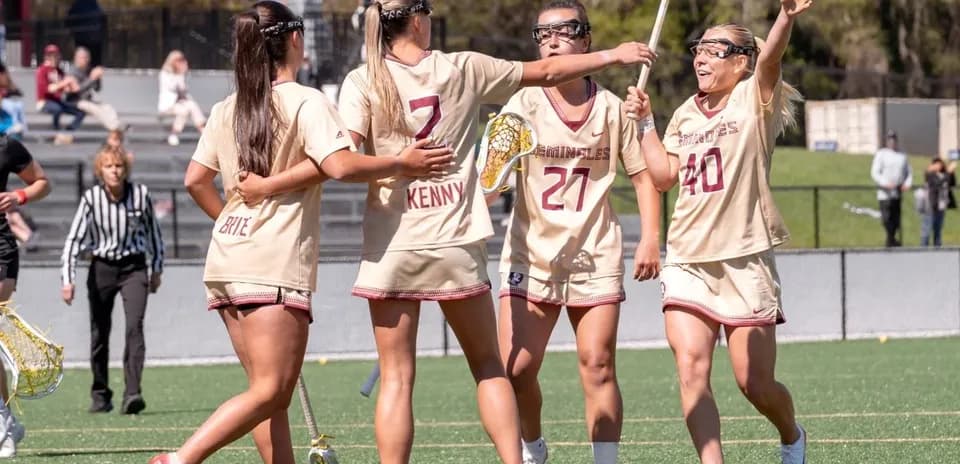Lacrosse players celebrating a goal on the field