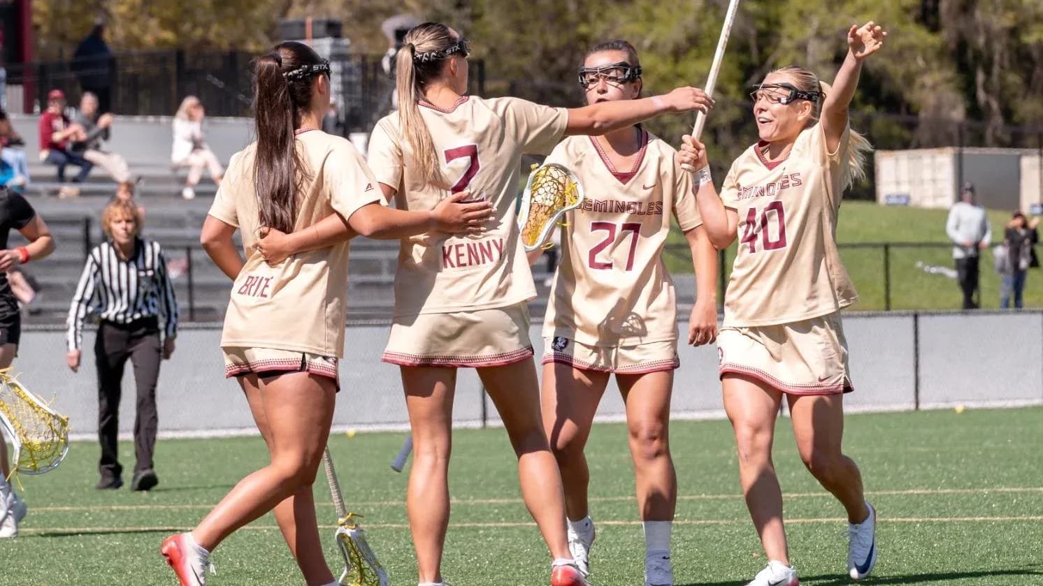Lacrosse players celebrating a goal on the field