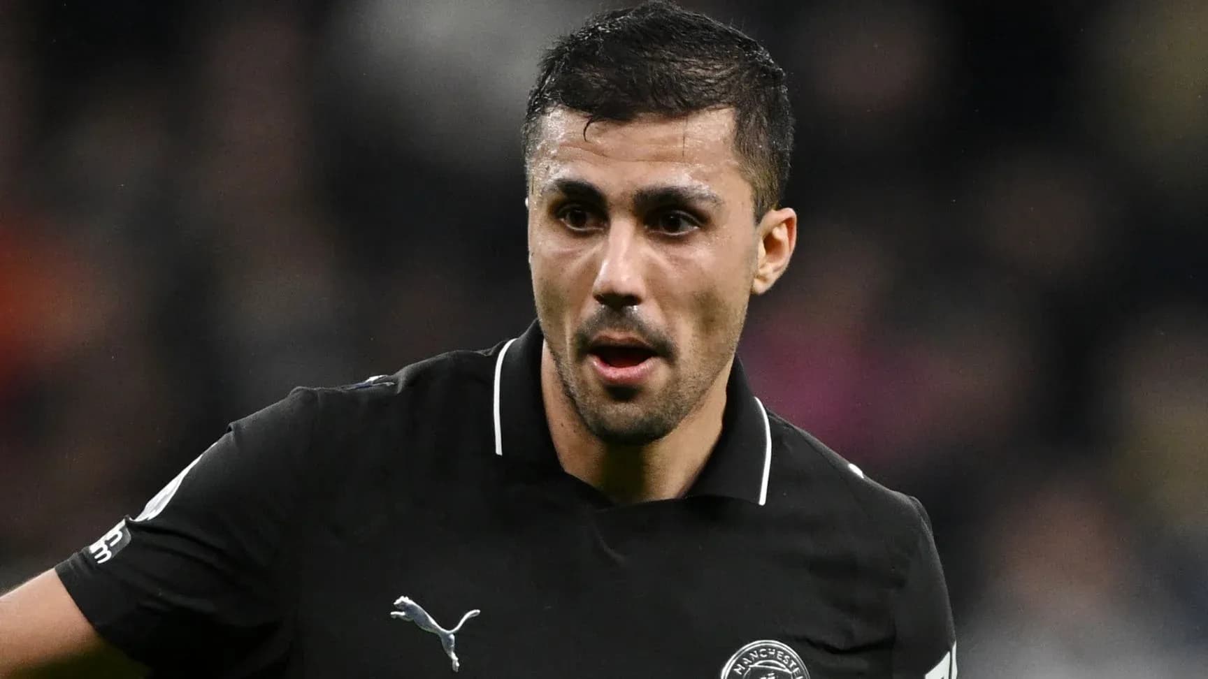 Player in black kit during match action