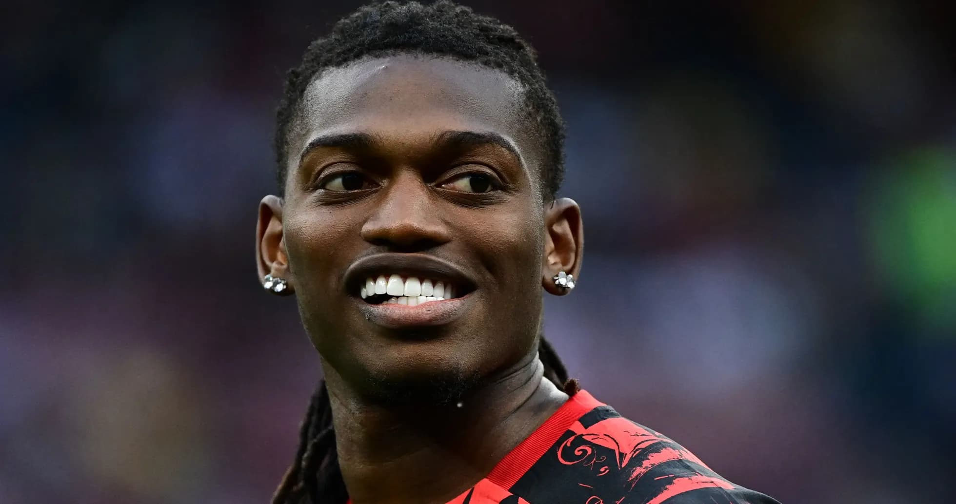 Player smiling in red and black jersey