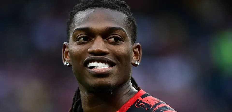 Player smiling in red and black jersey