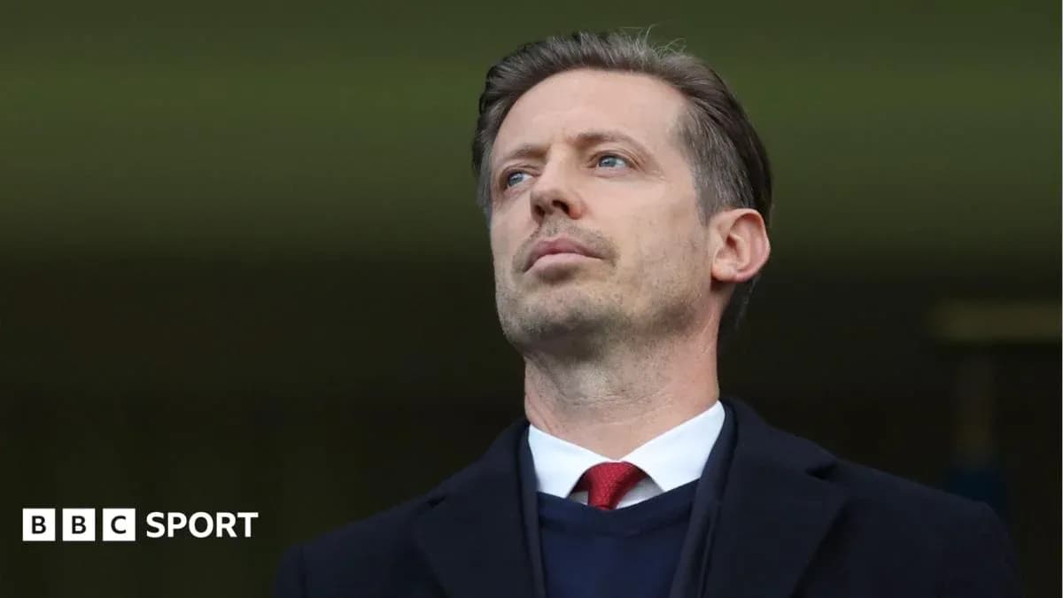 Man in suit observing from the stands
