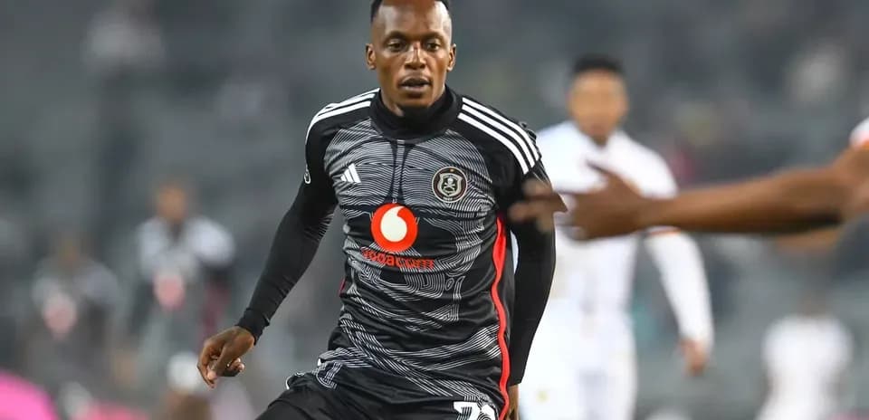 Player in black jersey running during a match