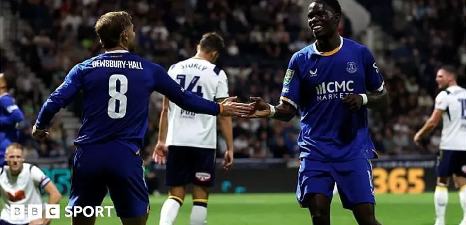 Two players celebrating a goal on the field