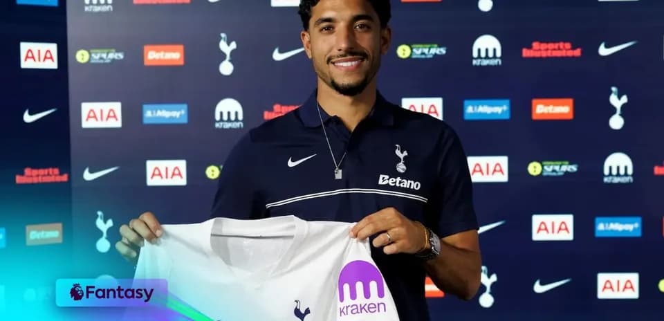 Player holding Tottenham Hotspur jersey at unveiling