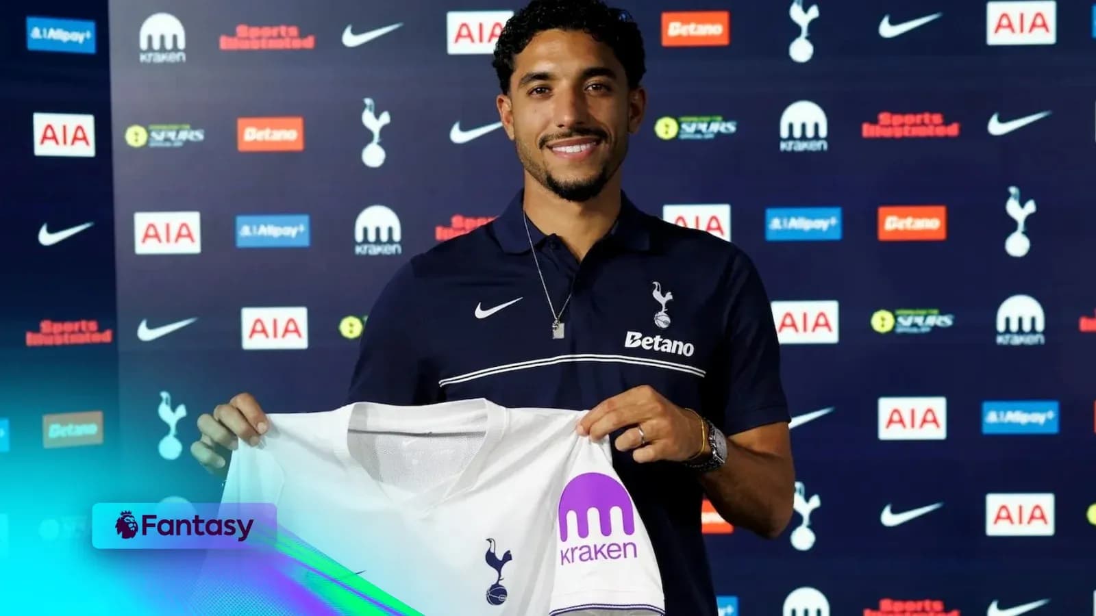 Player holding Tottenham Hotspur jersey at unveiling