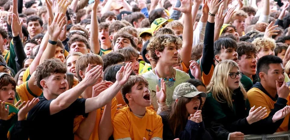 Crowd of fans cheering at sports event
