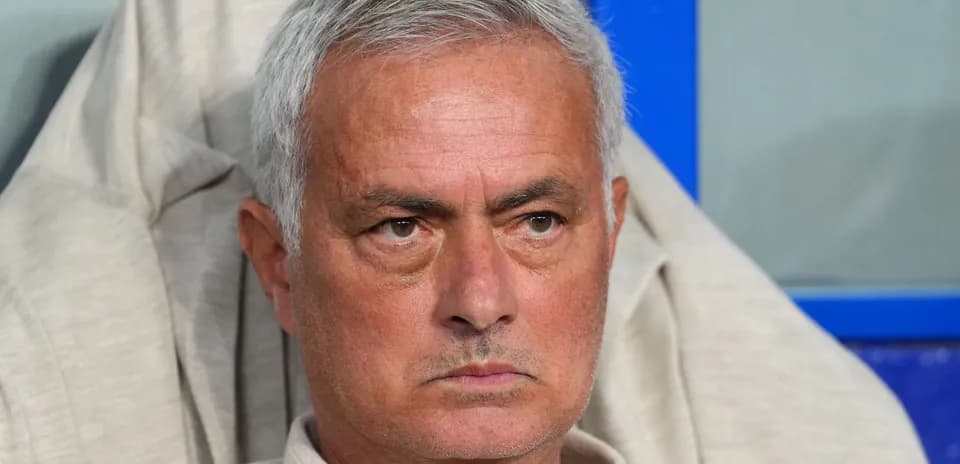 Manager sitting on bench during match
