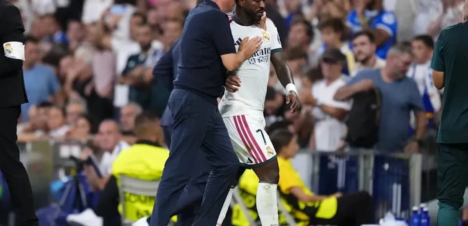 Coach interacting with player during match substitution