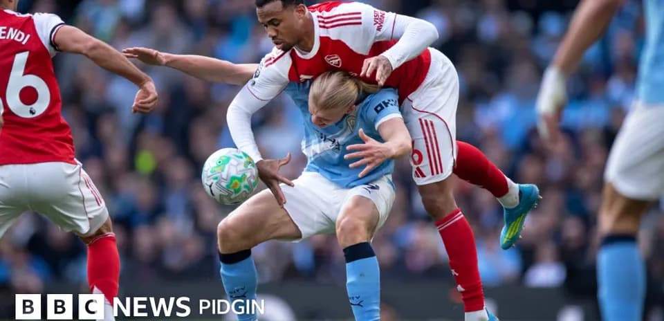 Player tackling opponent during competitive football match