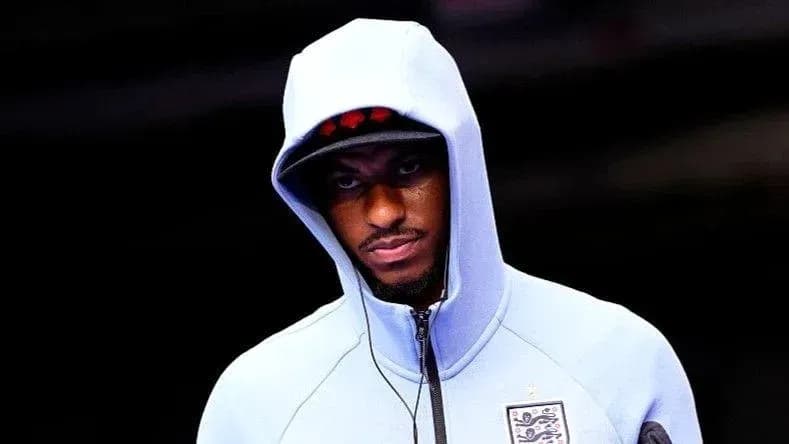 Player wearing a blue hoodie before the match