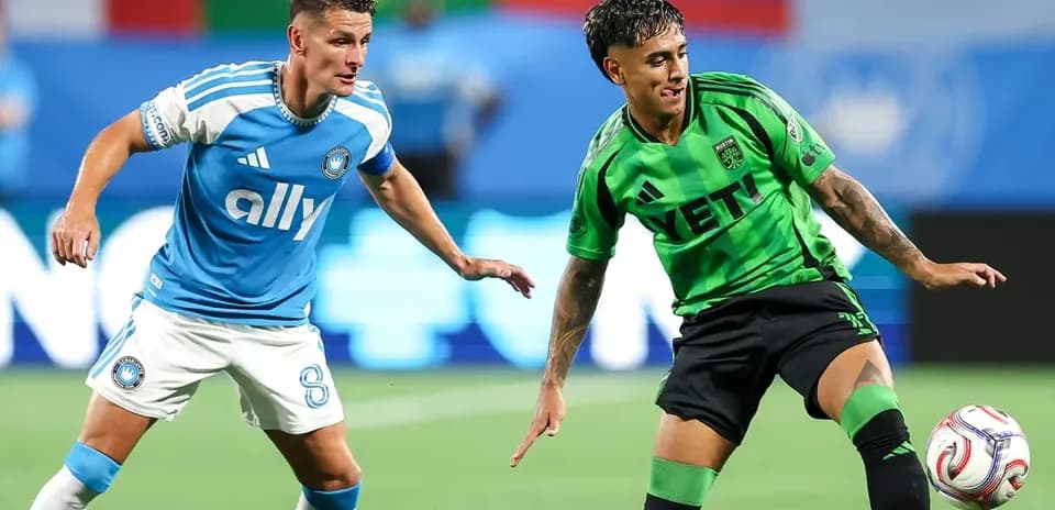 Players competing for the ball in MLS match