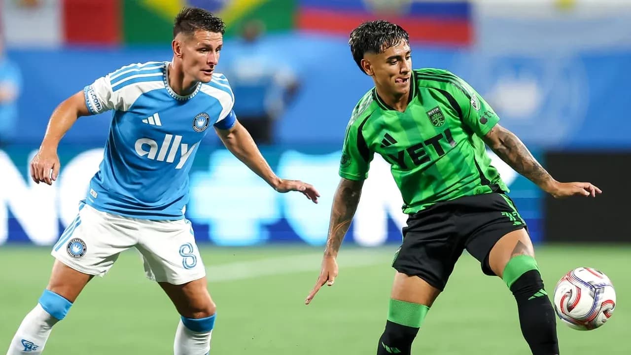 Players competing for the ball in MLS match