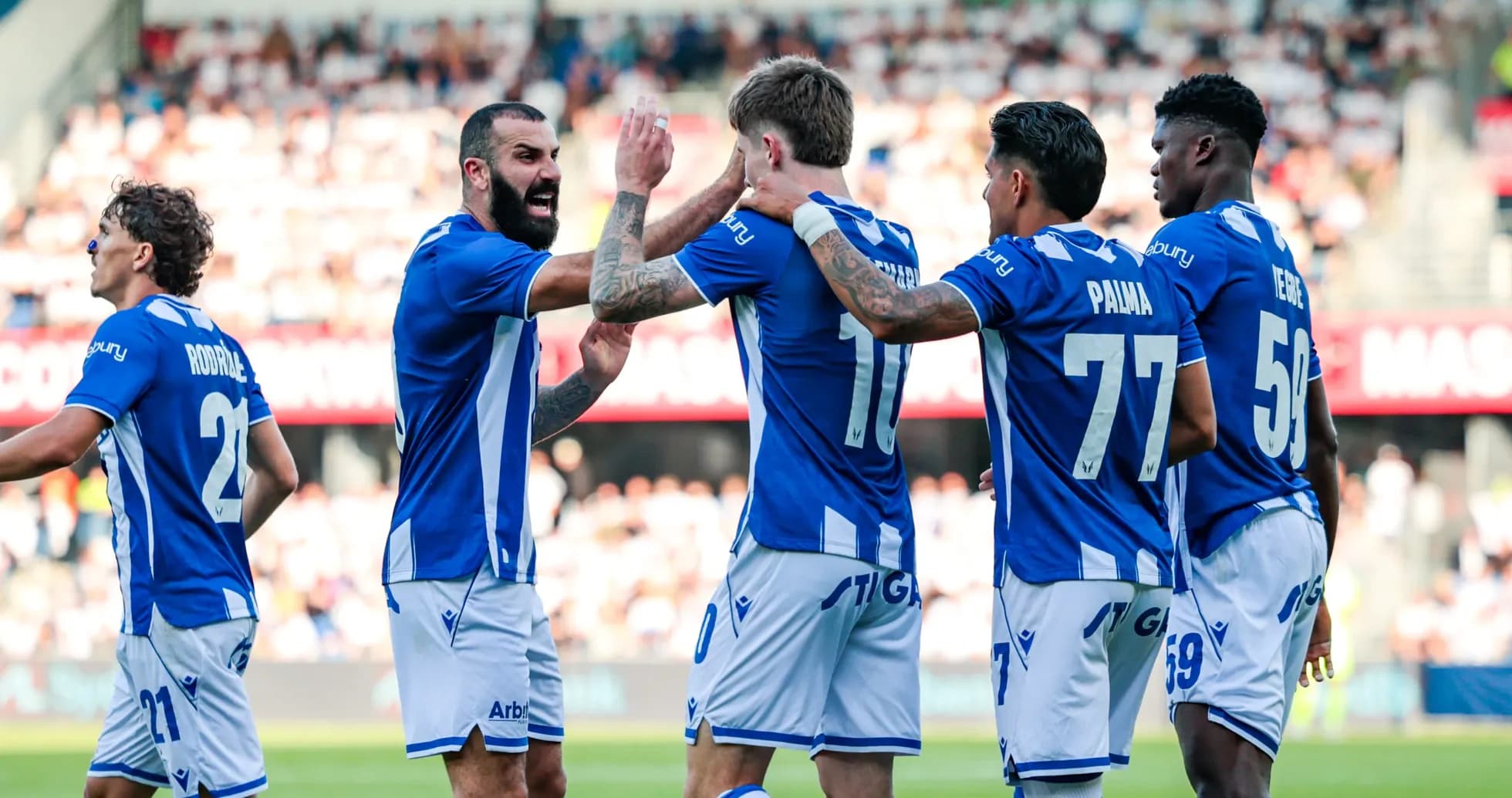 Players celebrating a goal during the match