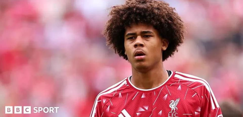 Young player wearing Liverpool jersey on the pitch