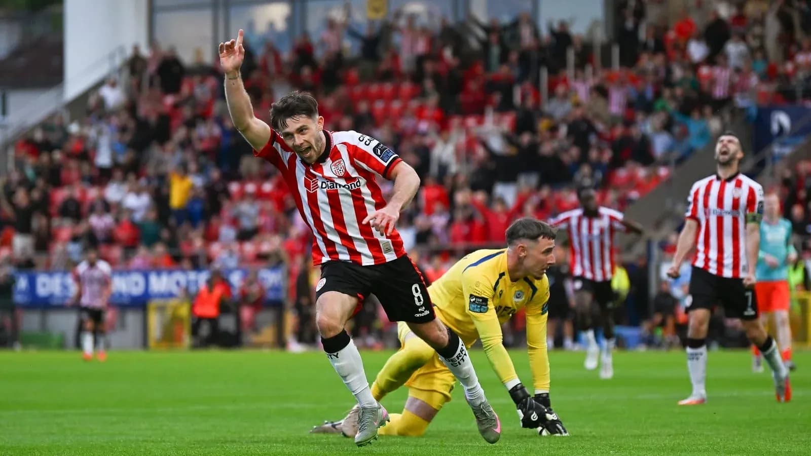 Player celebrating a goal with raised hand