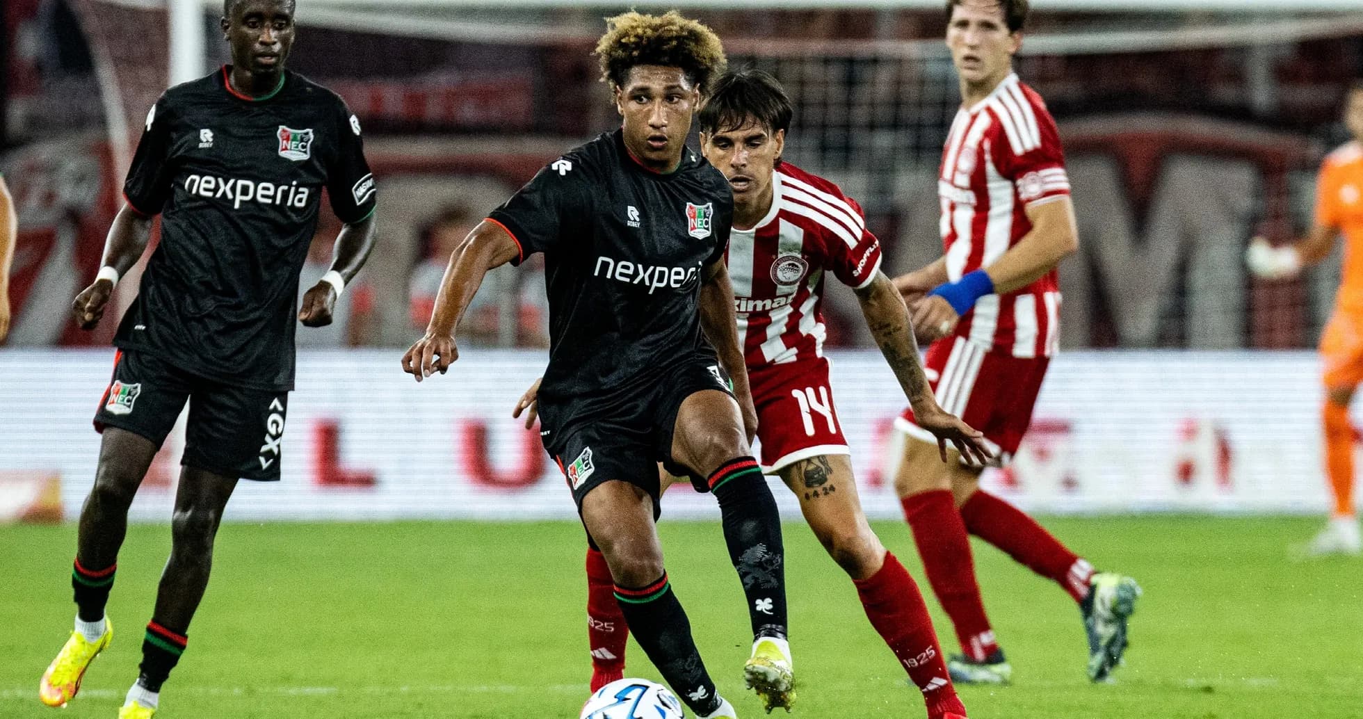 NEC Nijmegen player dribbling against Olympiakos