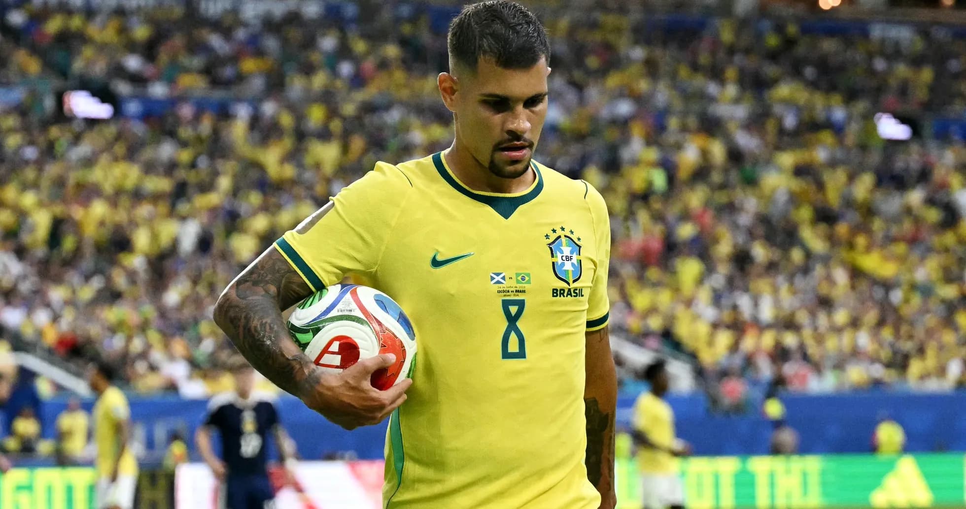 Player wearing Brazil jersey holding a soccer ball