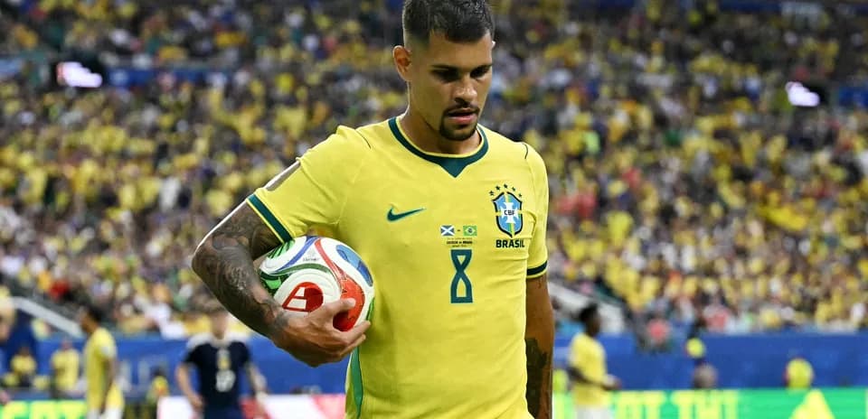 Player wearing Brazil jersey holding a soccer ball