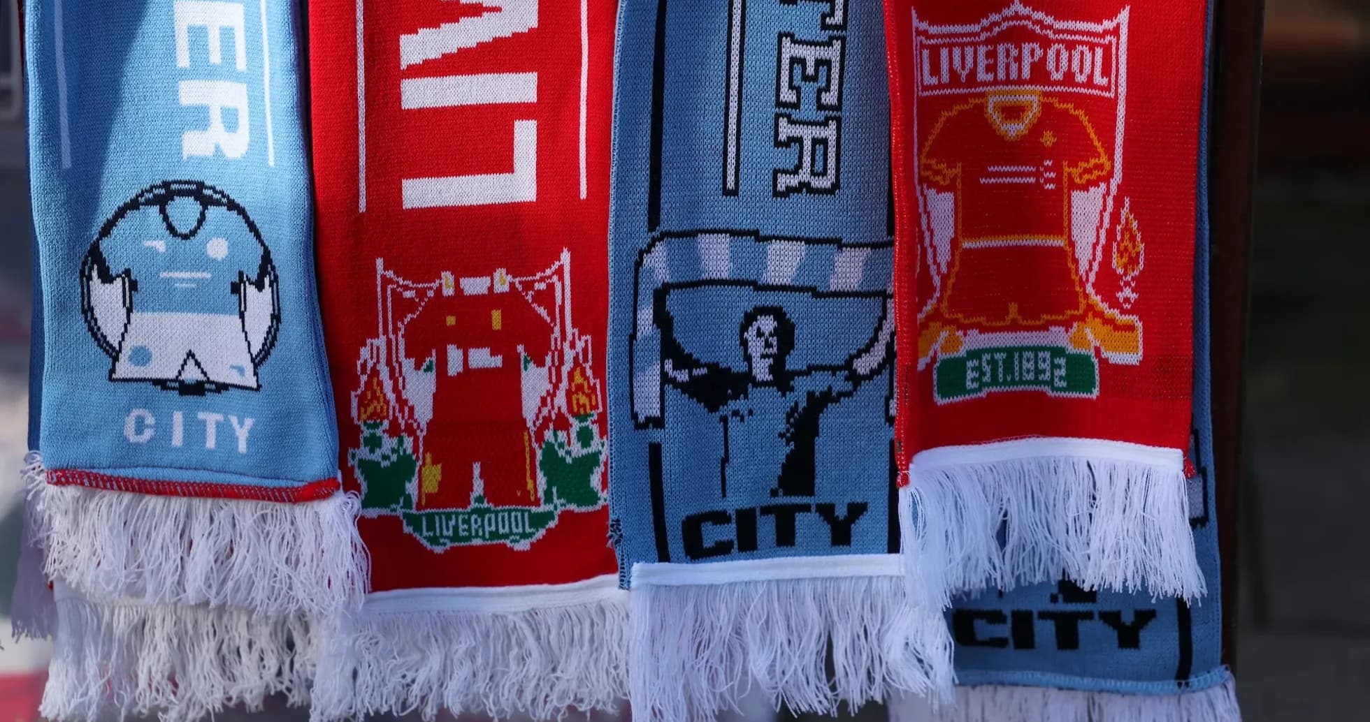 Liverpool and Manchester City scarves displayed