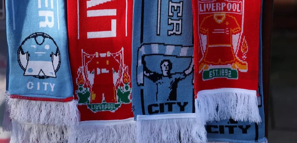 Liverpool and Manchester City scarves displayed