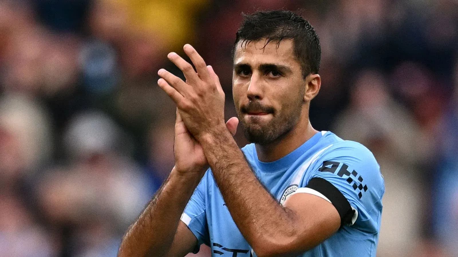 Player applauding fans after match in stadium