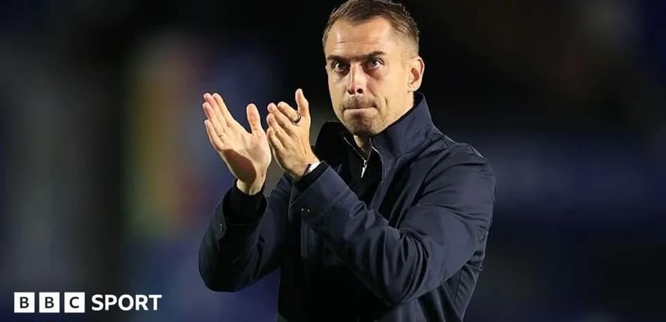 Manager applauding during a match or event