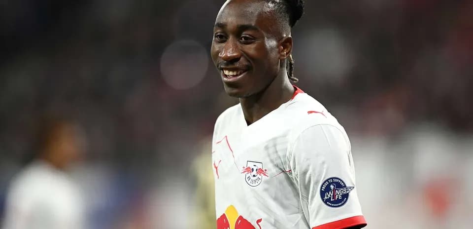 Player smiling during match wearing RB Leipzig jersey