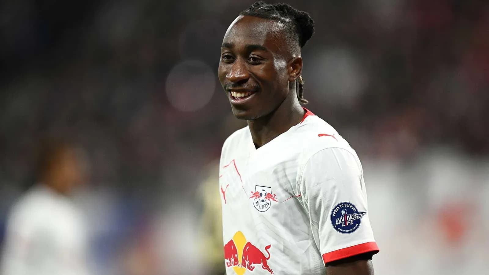 Player smiling during match wearing RB Leipzig jersey