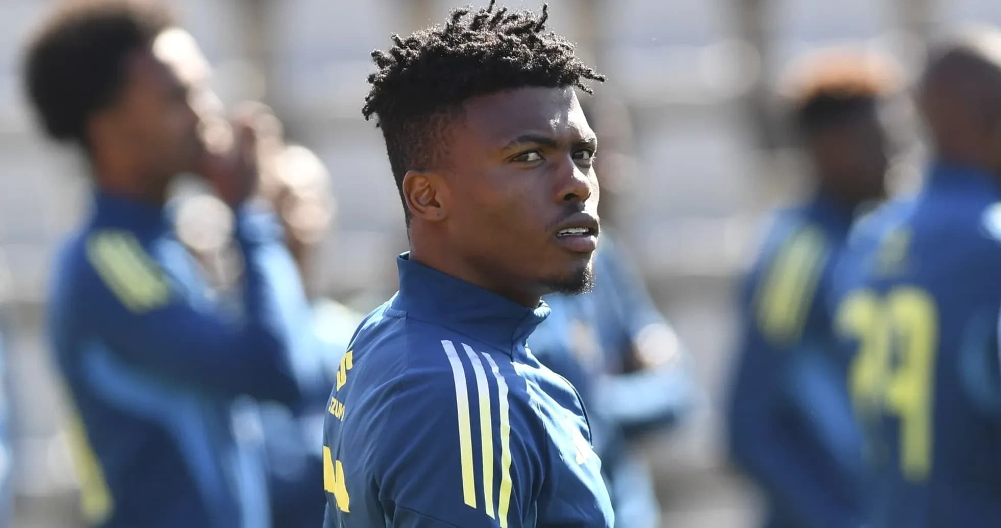 Player in training session with teammates in background