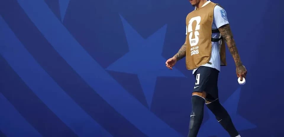 Player walking on field wearing training bib