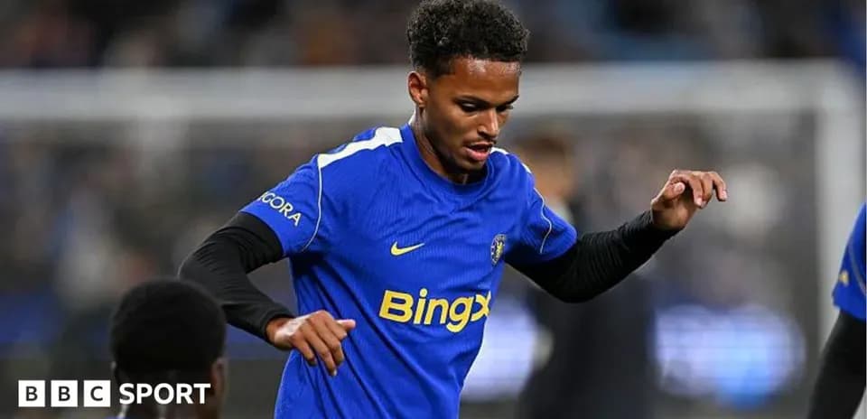 Player in blue jersey warming up on pitch