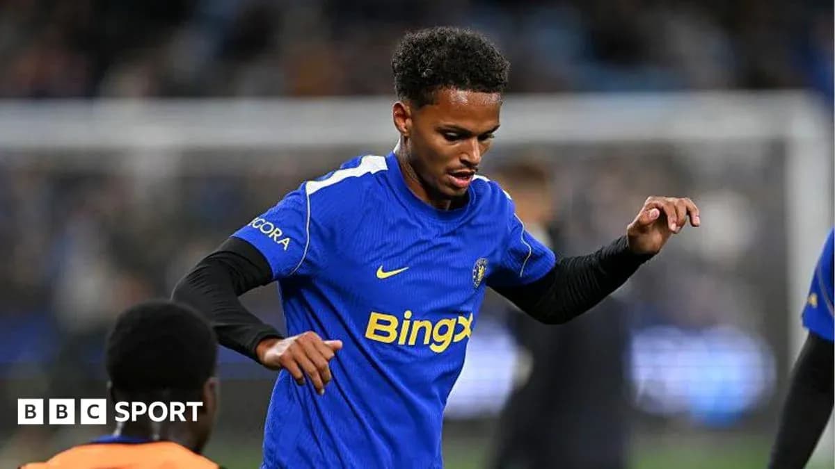 Player in blue jersey warming up on pitch