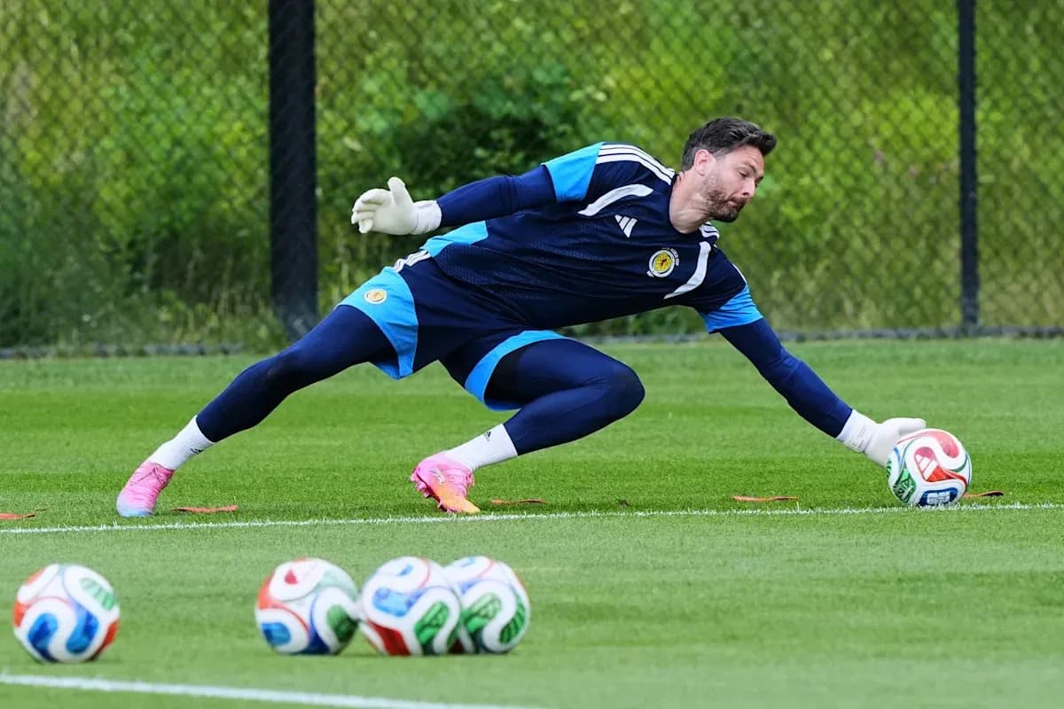 Goalkeeper diving to save a soccer ball during practice