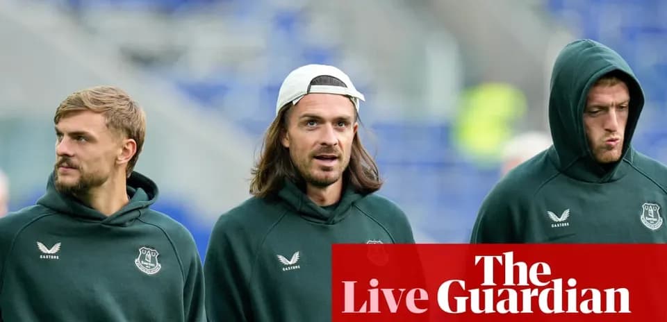 Three Everton players walking before the match