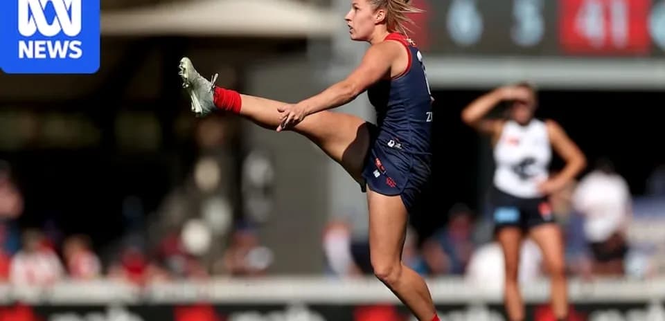 Player kicking ball during AFL match action