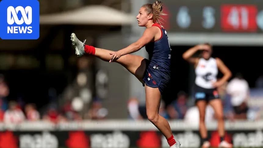 Player kicking ball during AFL match action