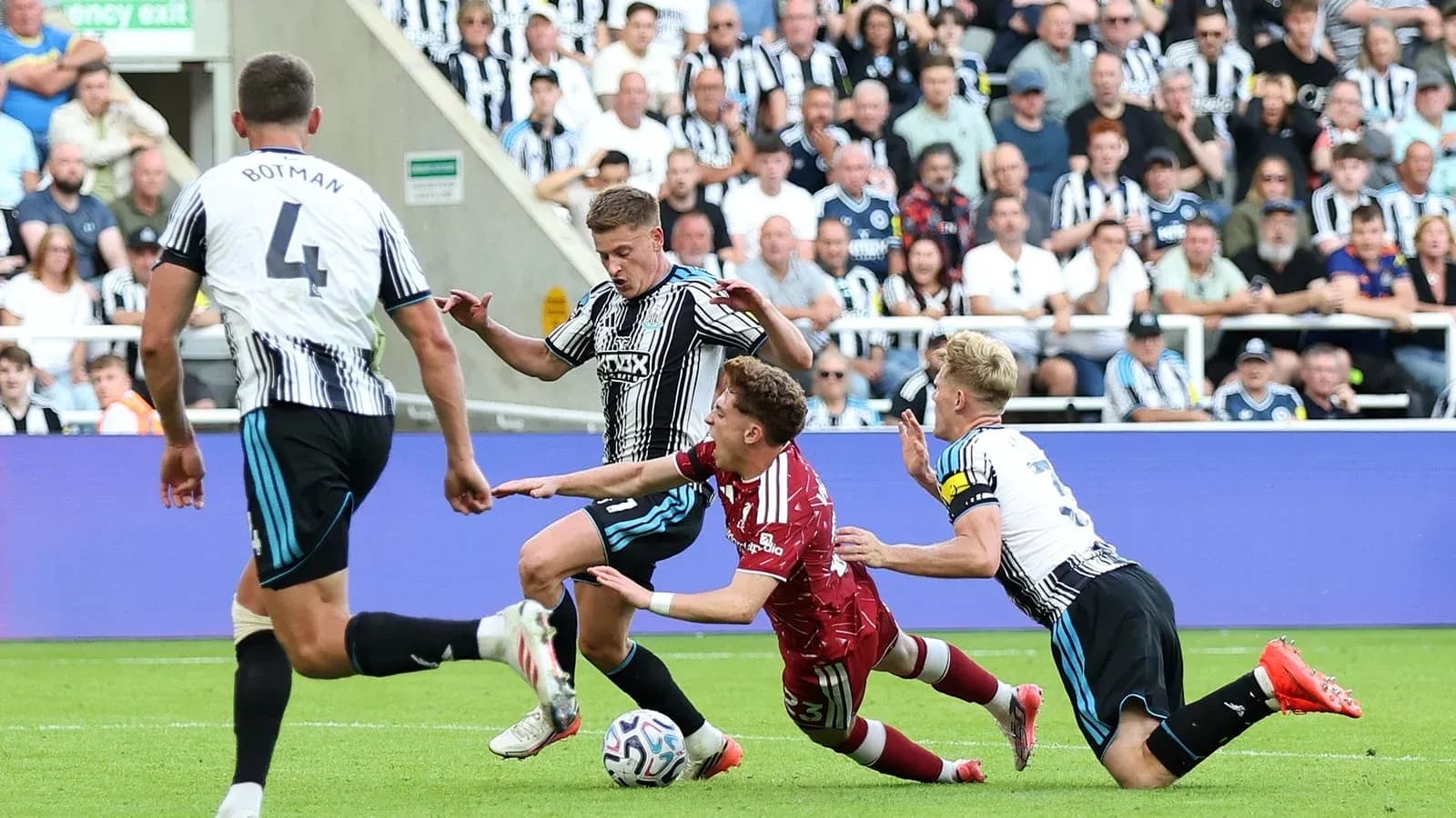 Players contesting the ball during a football match