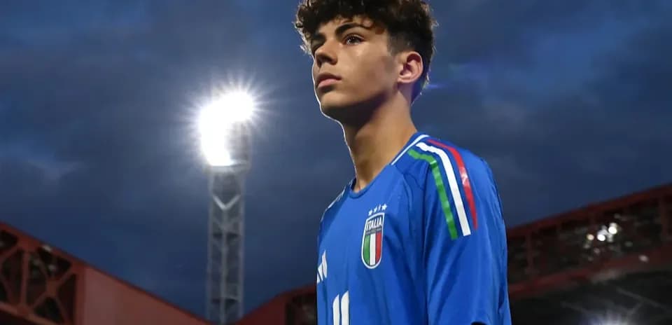 Young player in Italy jersey under stadium lights
