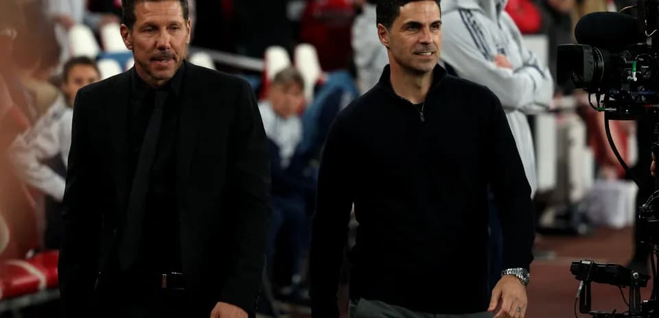 Two football managers walking before a match